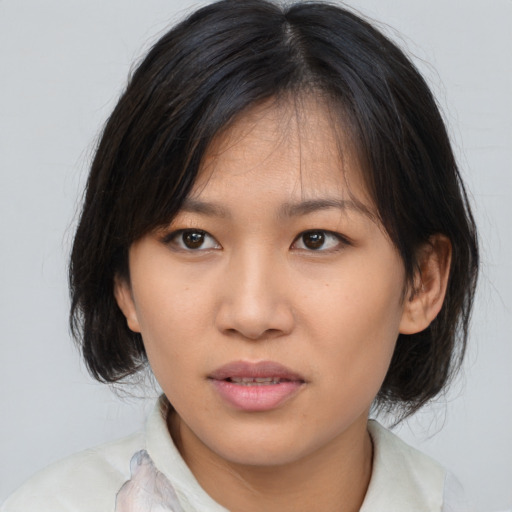 Neutral asian young-adult female with medium  brown hair and brown eyes