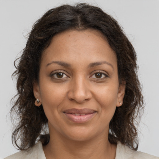 Joyful black young-adult female with medium  brown hair and brown eyes
