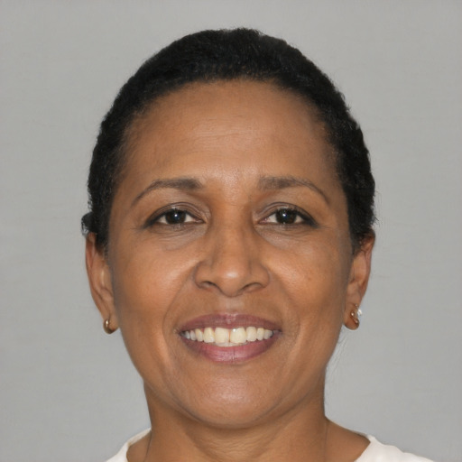 Joyful black adult female with short  black hair and brown eyes