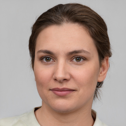 Joyful white young-adult female with medium  brown hair and brown eyes