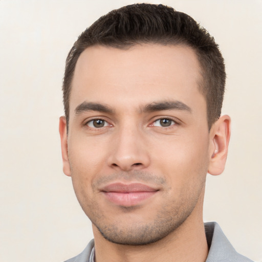 Joyful white young-adult male with short  black hair and brown eyes