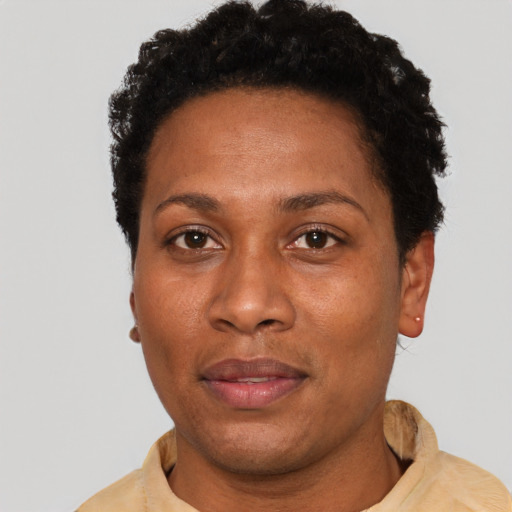 Joyful black adult female with short  black hair and brown eyes