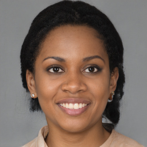 Joyful black young-adult female with medium  black hair and brown eyes