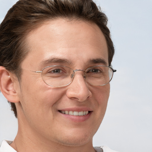 Joyful white adult male with short  brown hair and grey eyes