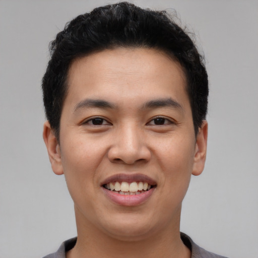 Joyful asian young-adult male with short  black hair and brown eyes