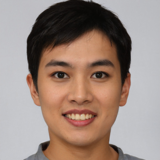 Joyful asian young-adult male with short  brown hair and brown eyes