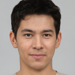 Joyful asian young-adult male with short  brown hair and brown eyes