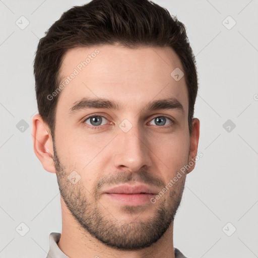 Joyful white young-adult male with short  brown hair and grey eyes