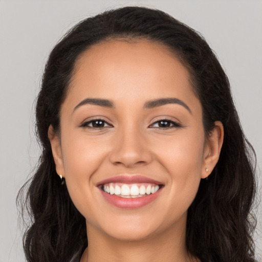 Joyful white young-adult female with long  brown hair and brown eyes