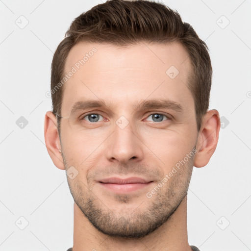 Joyful white young-adult male with short  brown hair and grey eyes