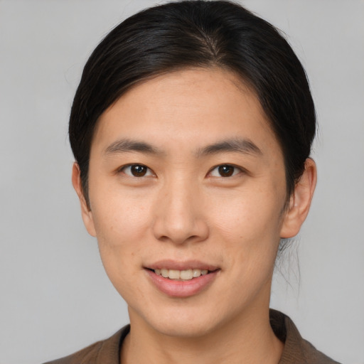 Joyful asian young-adult male with medium  brown hair and brown eyes