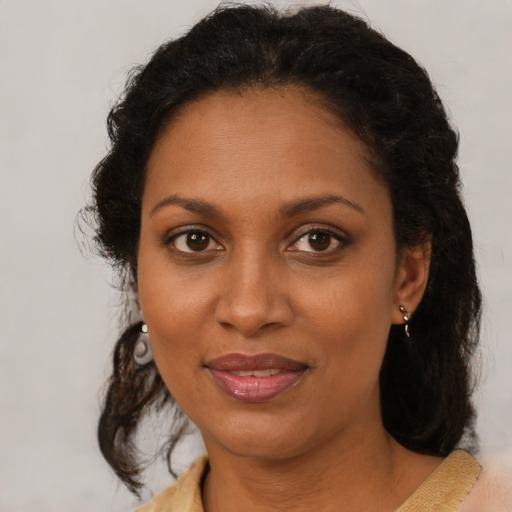 Joyful black adult female with short  brown hair and brown eyes