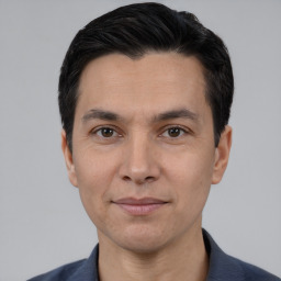 Joyful white adult male with short  black hair and brown eyes