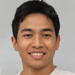 Joyful asian young-adult male with short  black hair and brown eyes