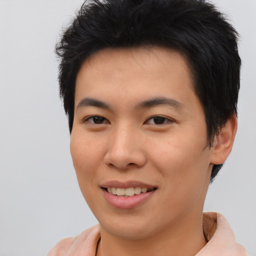 Joyful asian young-adult male with short  brown hair and brown eyes