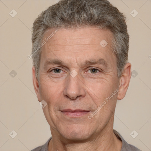 Joyful white middle-aged male with short  gray hair and brown eyes