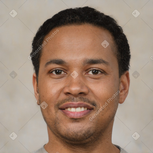 Joyful black young-adult male with short  black hair and brown eyes