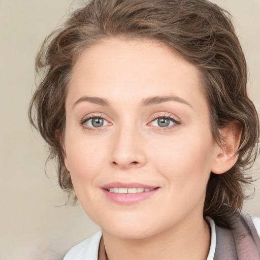 Joyful white young-adult female with medium  brown hair and blue eyes