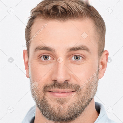 Joyful white young-adult male with short  brown hair and grey eyes