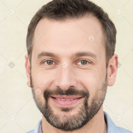 Joyful white adult male with short  brown hair and brown eyes