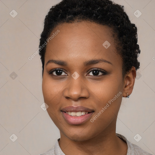 Joyful black young-adult female with short  black hair and brown eyes