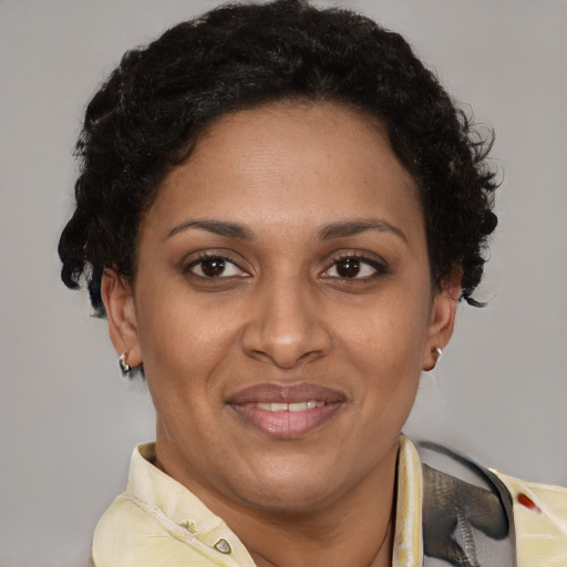 Joyful latino adult female with short  brown hair and brown eyes