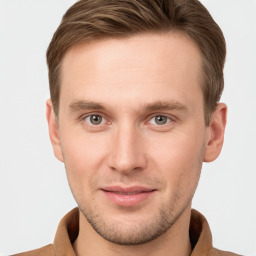 Joyful white young-adult male with short  brown hair and grey eyes