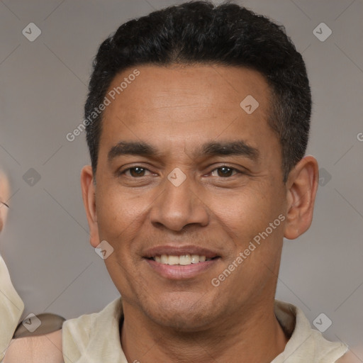 Joyful latino adult male with short  brown hair and brown eyes