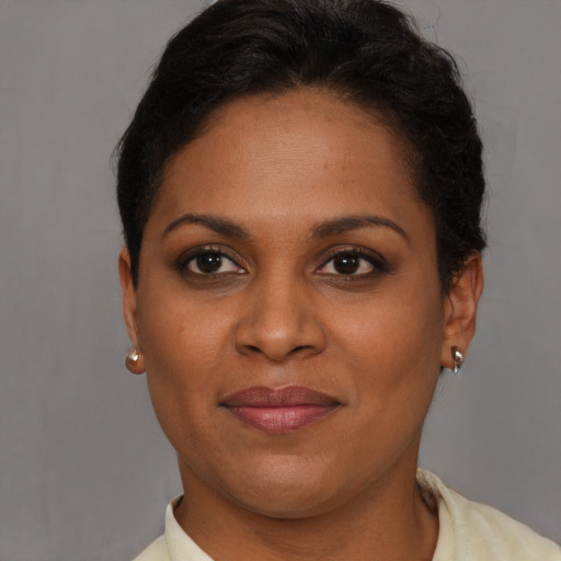 Joyful black young-adult female with short  brown hair and brown eyes