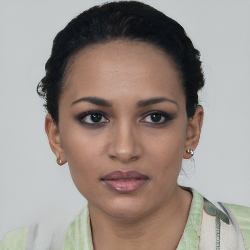 Joyful latino young-adult female with short  black hair and brown eyes