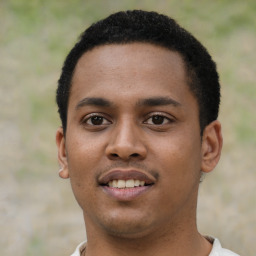 Joyful black young-adult male with short  black hair and brown eyes