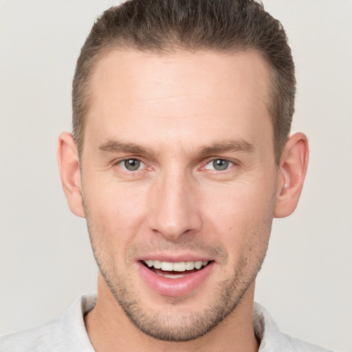 Joyful white young-adult male with short  brown hair and brown eyes