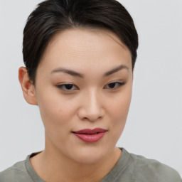 Joyful asian young-adult female with short  brown hair and brown eyes