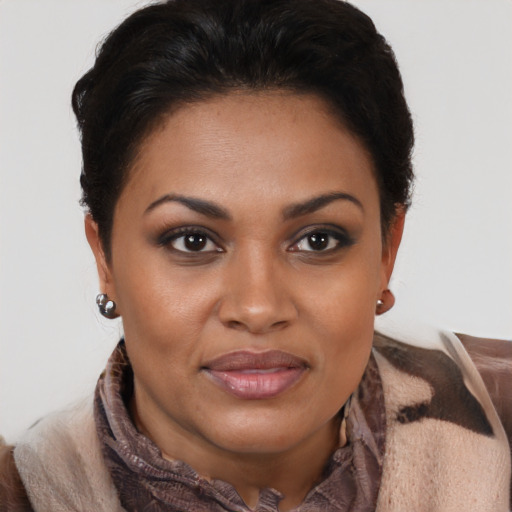 Joyful black young-adult female with short  brown hair and brown eyes