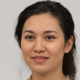 Joyful white adult female with medium  brown hair and brown eyes