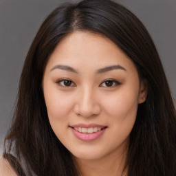 Joyful asian young-adult female with long  brown hair and brown eyes