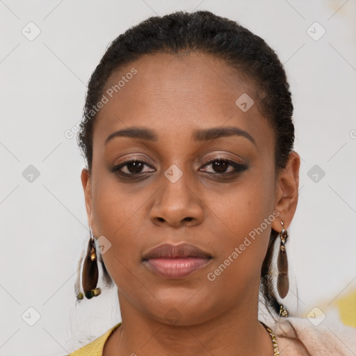 Joyful black young-adult female with short  brown hair and brown eyes