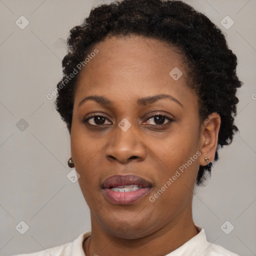 Joyful black young-adult female with short  black hair and brown eyes