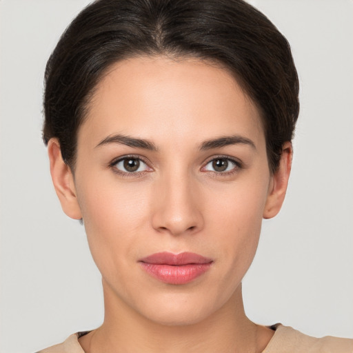 Joyful white young-adult female with short  brown hair and brown eyes