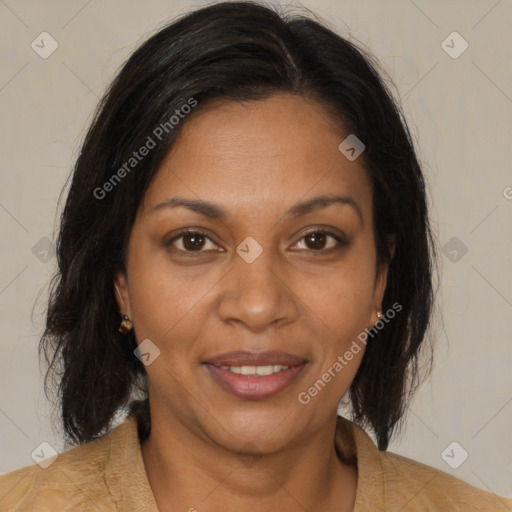 Joyful black adult female with medium  brown hair and brown eyes