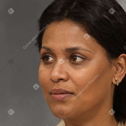 Joyful black adult female with medium  brown hair and brown eyes