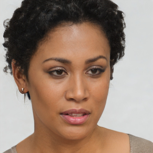 Joyful latino young-adult female with short  brown hair and brown eyes