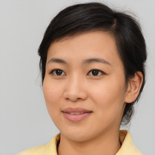 Joyful asian young-adult female with medium  brown hair and brown eyes