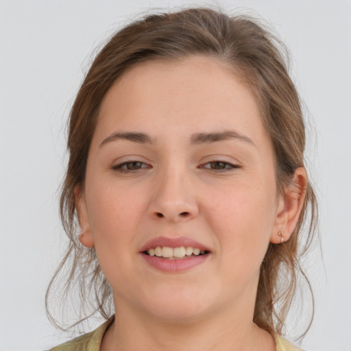 Joyful white young-adult female with medium  brown hair and brown eyes