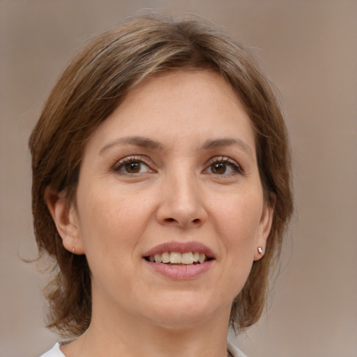 Joyful white adult female with medium  brown hair and brown eyes