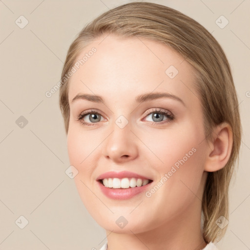 Joyful white young-adult female with medium  brown hair and blue eyes