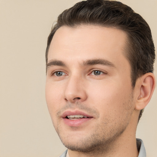 Joyful white young-adult male with short  brown hair and brown eyes