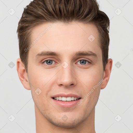 Joyful white young-adult male with short  brown hair and grey eyes