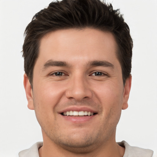 Joyful white young-adult male with short  brown hair and brown eyes