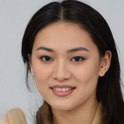 Joyful asian young-adult female with long  brown hair and brown eyes